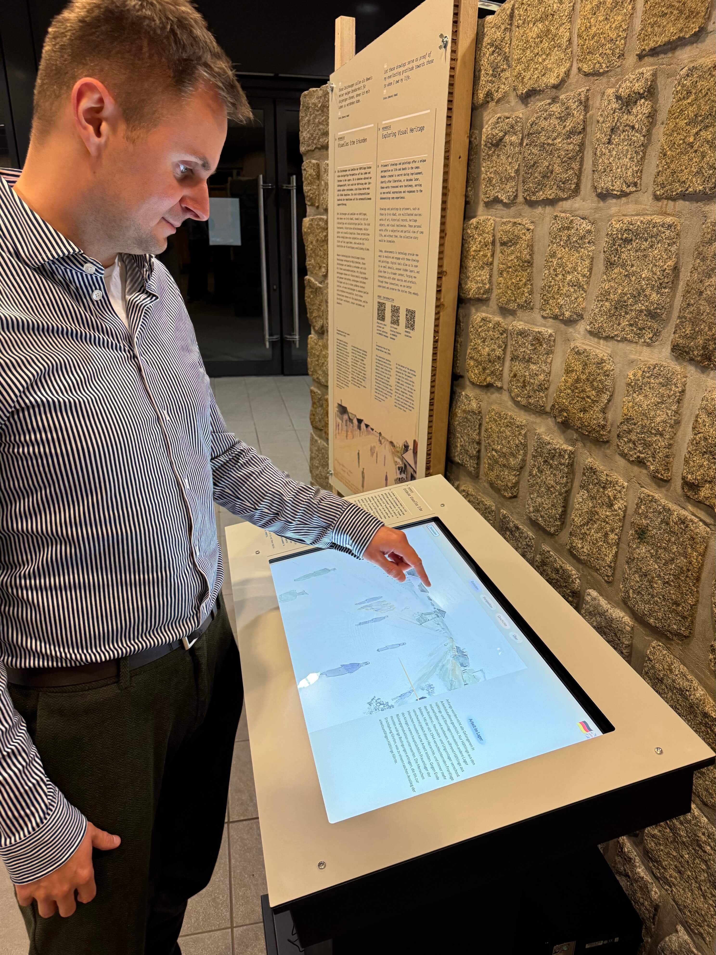 The interactive prisoner art explorer allows you to inspect details in a watercolor painting of a perspective view of the Bergen-Belsen Concentration  Camp and offers a guided storytelling tour through the various details of the painting. This is currently exhibited at the memorial of Bergen-Belsen, Germany. 2024